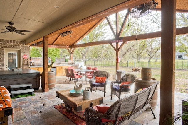 view of patio / terrace featuring a bar and ceiling fan