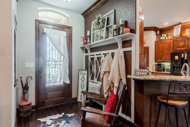 mudroom featuring crown molding and dark wood-type flooring