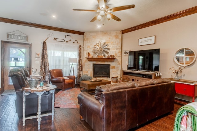 living room featuring dark wood-type flooring, ceiling fan, ornamental molding, and a fireplace