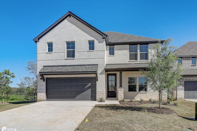 view of front of home featuring a front lawn and a garage