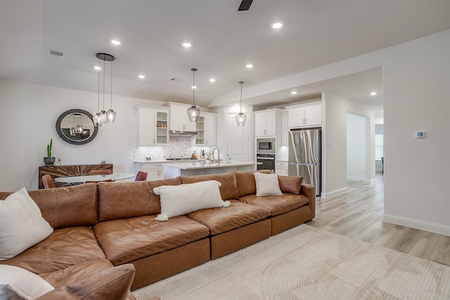 living room with sink and light wood-type flooring