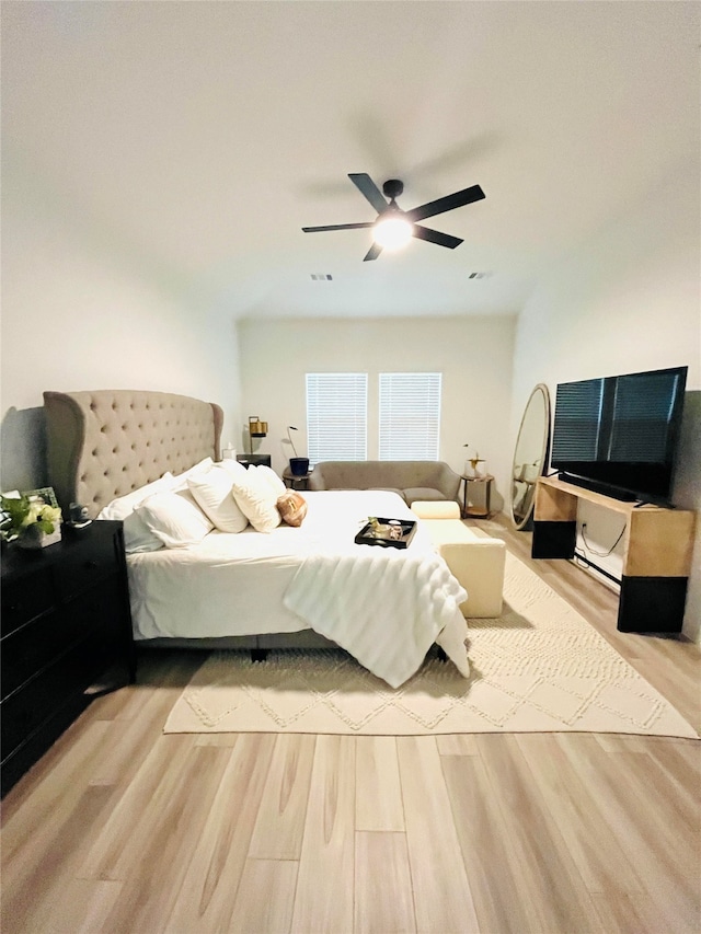 bedroom with light hardwood / wood-style floors and ceiling fan