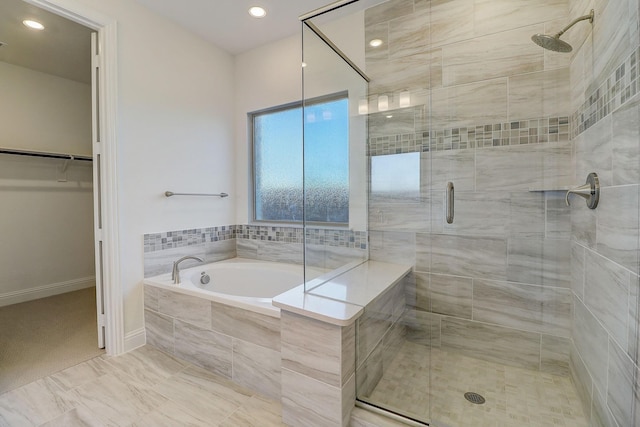 bathroom with separate shower and tub