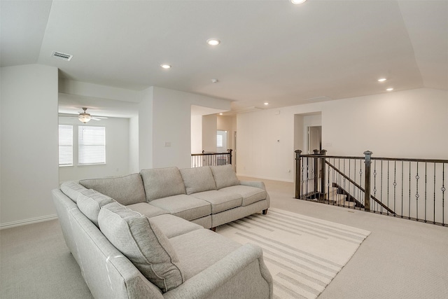 carpeted living room with lofted ceiling and ceiling fan