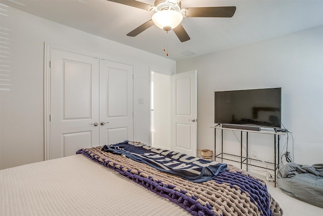 carpeted bedroom with a closet and ceiling fan