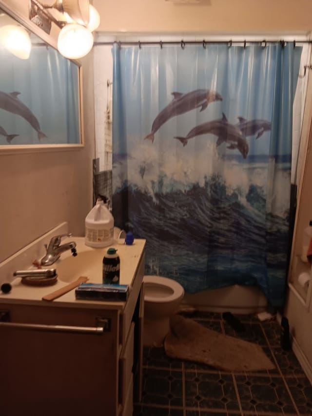 bathroom with vanity, a shower with curtain, toilet, and tile patterned floors