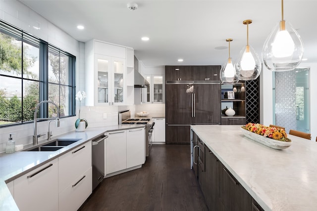 kitchen featuring white range, dark wood-type flooring, hanging light fixtures, dark brown cabinetry, and white cabinetry