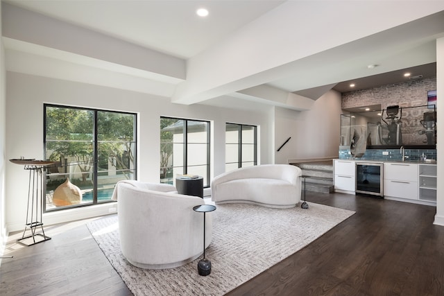 bedroom with dark wood-type flooring, wine cooler, and sink