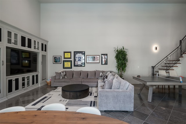 tiled living room with a towering ceiling