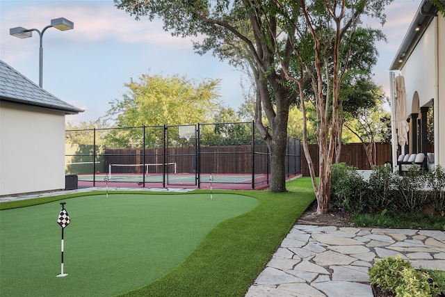 view of community featuring tennis court