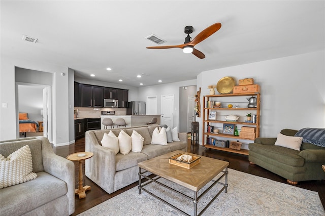 living room with hardwood / wood-style flooring and ceiling fan