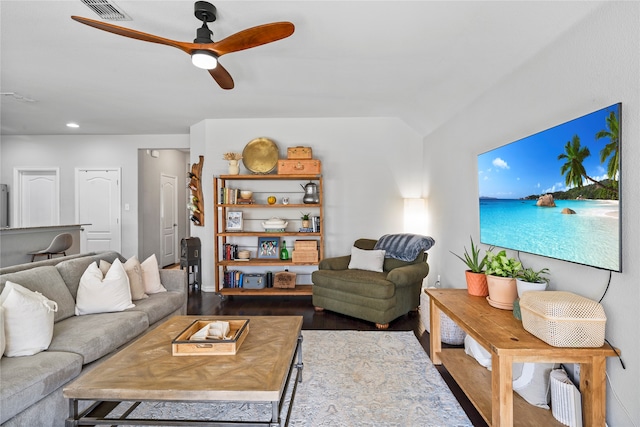 living room featuring ceiling fan, dark wood-type flooring, and lofted ceiling