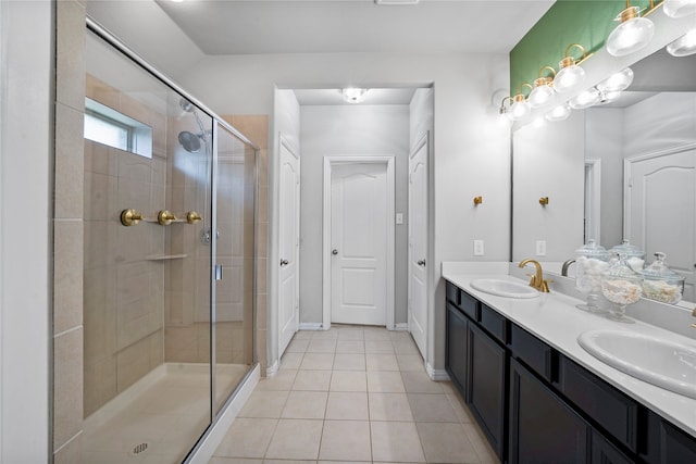 bathroom featuring tile patterned floors, a shower with door, and vanity