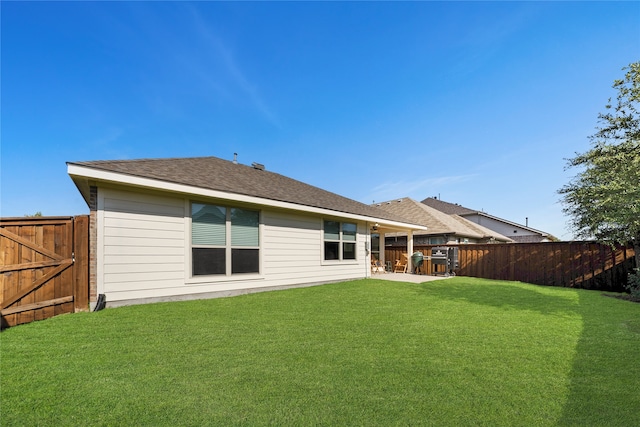 back of house with a yard and a patio area