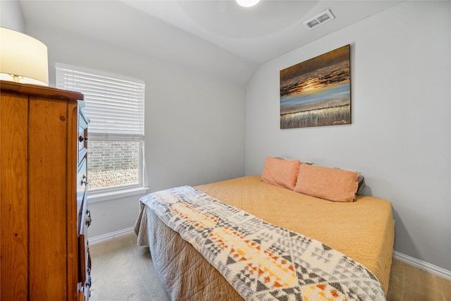 bedroom featuring lofted ceiling and carpet floors