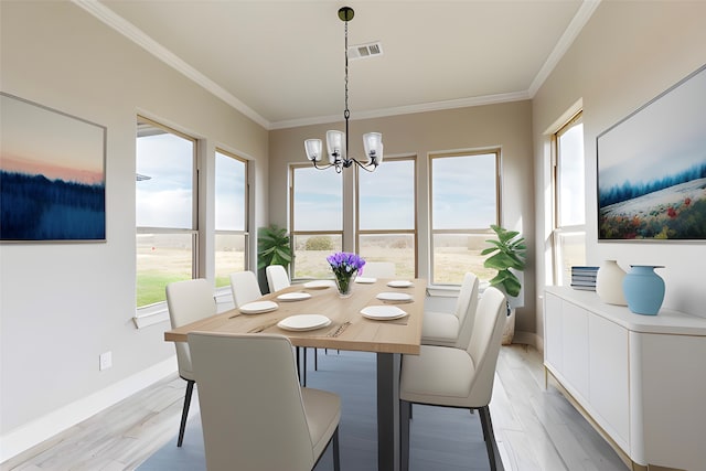 dining room featuring light wood finished floors, a wealth of natural light, visible vents, and crown molding