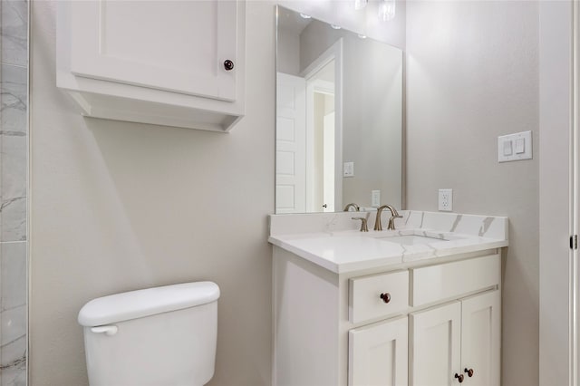 bathroom with toilet and vanity