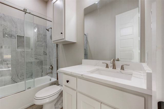 full bath with shower / bath combination with glass door, vanity, and toilet