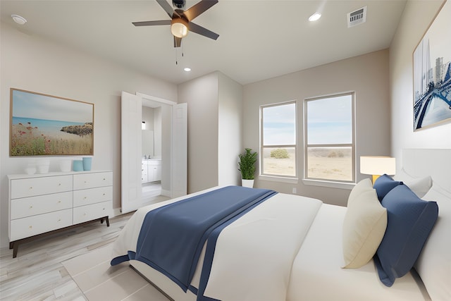 bedroom featuring visible vents, a ceiling fan, ensuite bath, light wood-style floors, and recessed lighting