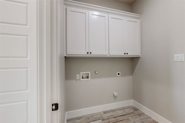 laundry area featuring cabinet space, baseboards, gas dryer hookup, washer hookup, and electric dryer hookup