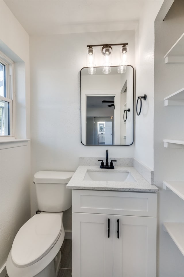 bathroom featuring toilet and vanity