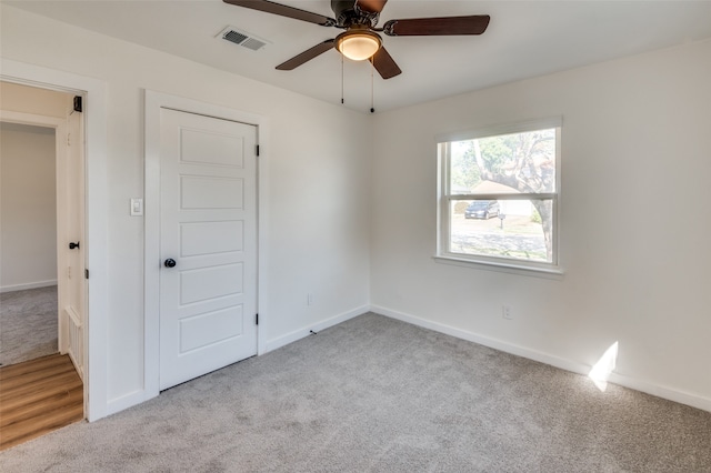 empty room featuring light carpet and ceiling fan