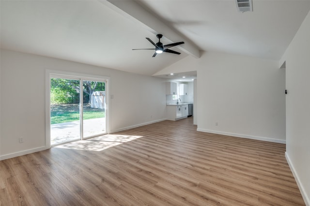 unfurnished living room featuring vaulted ceiling with beams, light hardwood / wood-style flooring, sink, and ceiling fan