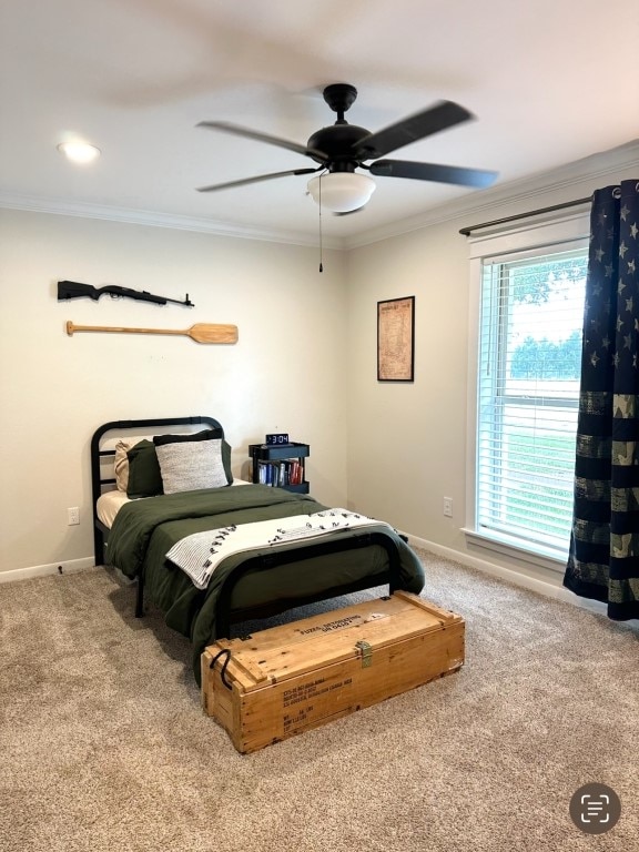 carpeted bedroom with ornamental molding and ceiling fan