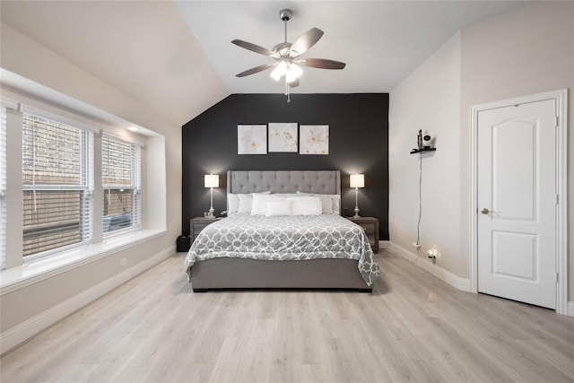 bedroom featuring vaulted ceiling, light hardwood / wood-style flooring, and ceiling fan