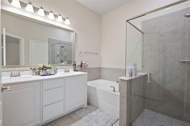 bathroom with vanity, independent shower and bath, and tile patterned flooring