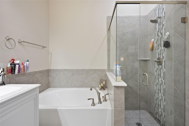 bathroom with vanity and independent shower and bath