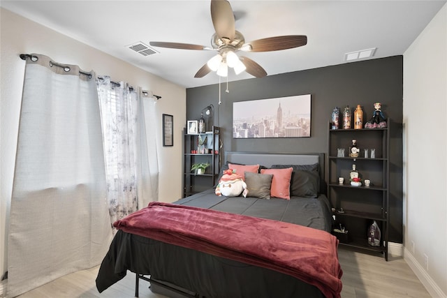 bedroom with light hardwood / wood-style floors and ceiling fan