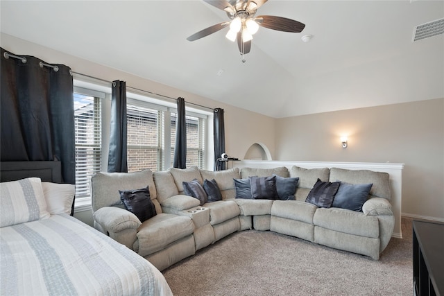 carpeted living room with ceiling fan and vaulted ceiling