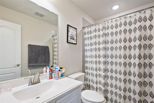 bathroom with vanity, toilet, and a shower with curtain