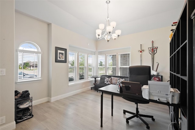 home office with a chandelier, light hardwood / wood-style floors, and plenty of natural light