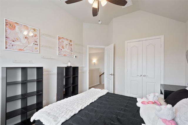 bedroom with lofted ceiling, a closet, and ceiling fan