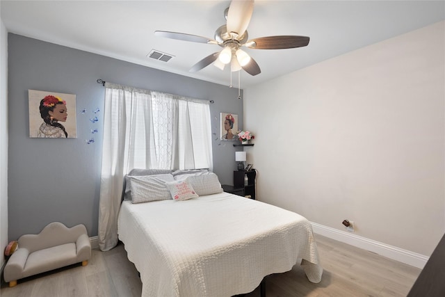 bedroom with ceiling fan and light hardwood / wood-style flooring