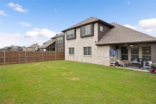 back of house with a patio area, a lawn, and ceiling fan