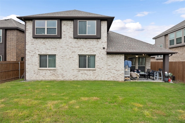 rear view of property with a patio, a wall unit AC, and a yard