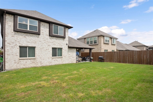 rear view of property with a patio area and a lawn