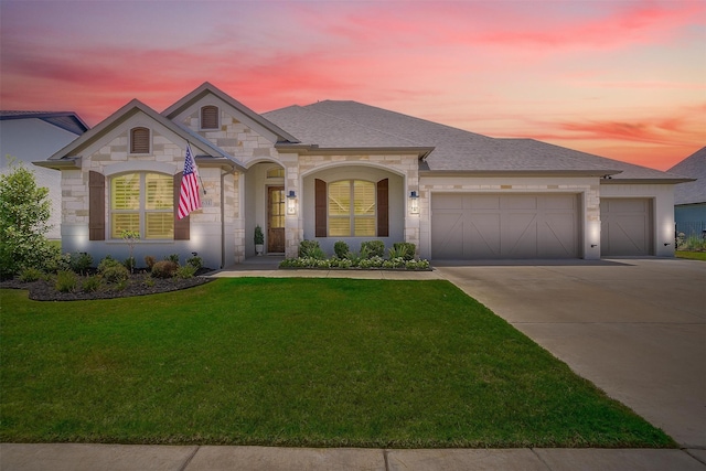 view of front of home featuring a garage and a lawn