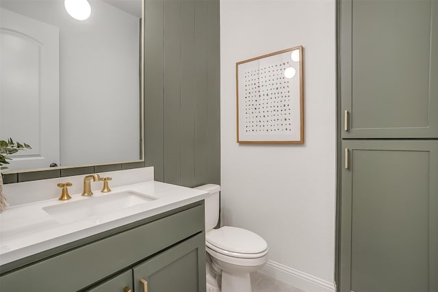 bathroom with toilet, vanity, and tile patterned flooring