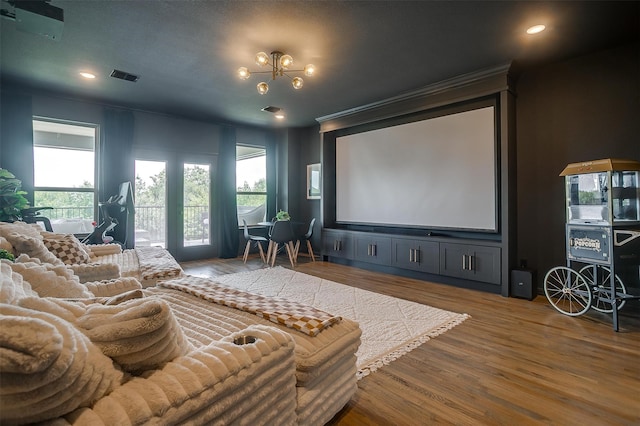 cinema with hardwood / wood-style flooring, a healthy amount of sunlight, and crown molding