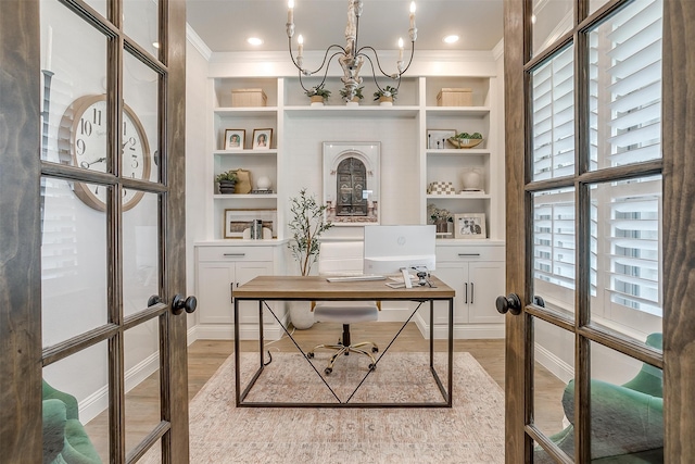 office with french doors, wood-type flooring, plenty of natural light, and built in shelves