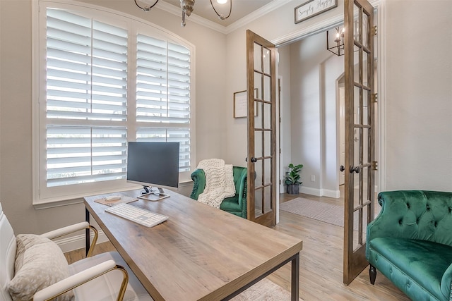 home office with french doors, crown molding, a notable chandelier, and light hardwood / wood-style flooring