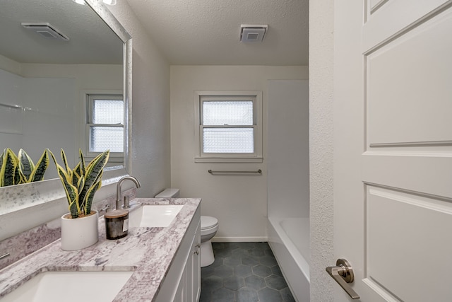 full bathroom featuring a textured ceiling, vanity, tile patterned floors, toilet, and shower / bathtub combination