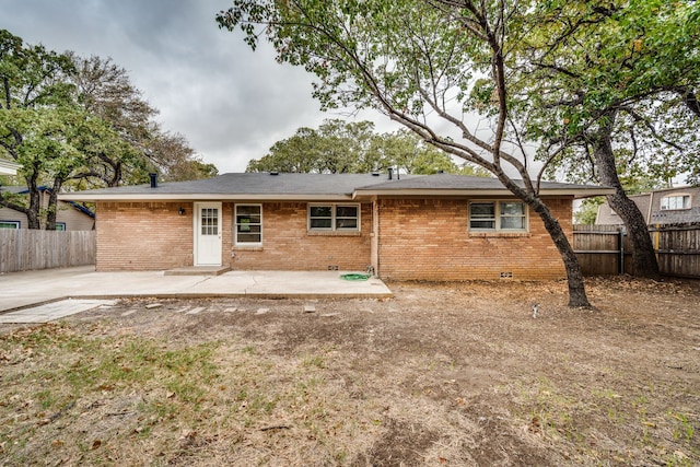 back of property with a patio