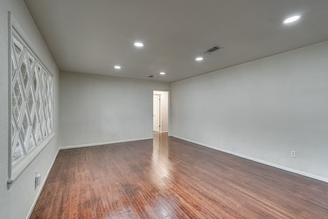 unfurnished room featuring dark hardwood / wood-style flooring