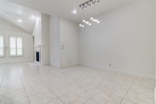 unfurnished living room featuring light tile patterned floors, a fireplace with raised hearth, lofted ceiling, recessed lighting, and baseboards