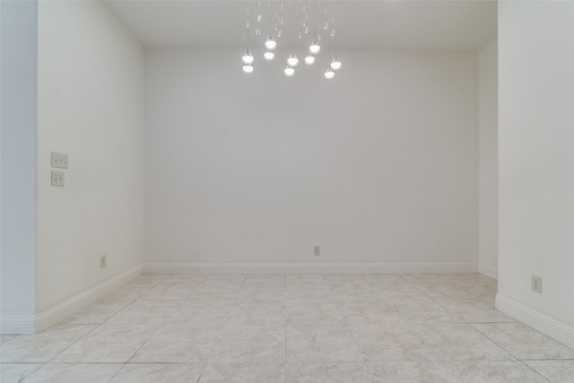 unfurnished room with light tile patterned flooring